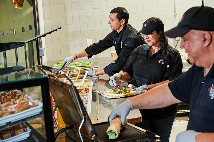 Pita Chip employees serving customers